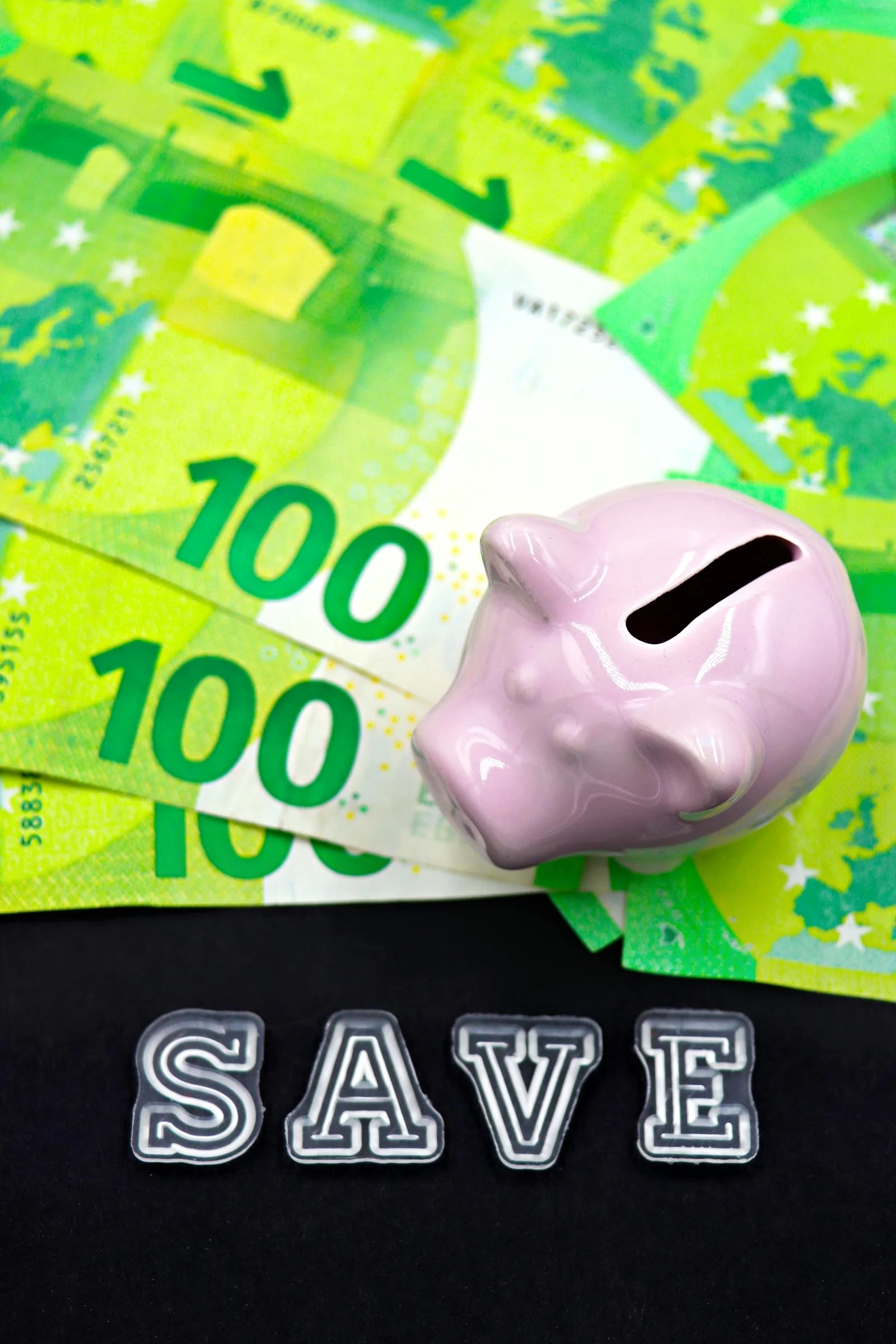 Pink piggy bank on euro banknotes symbolising retirement savings